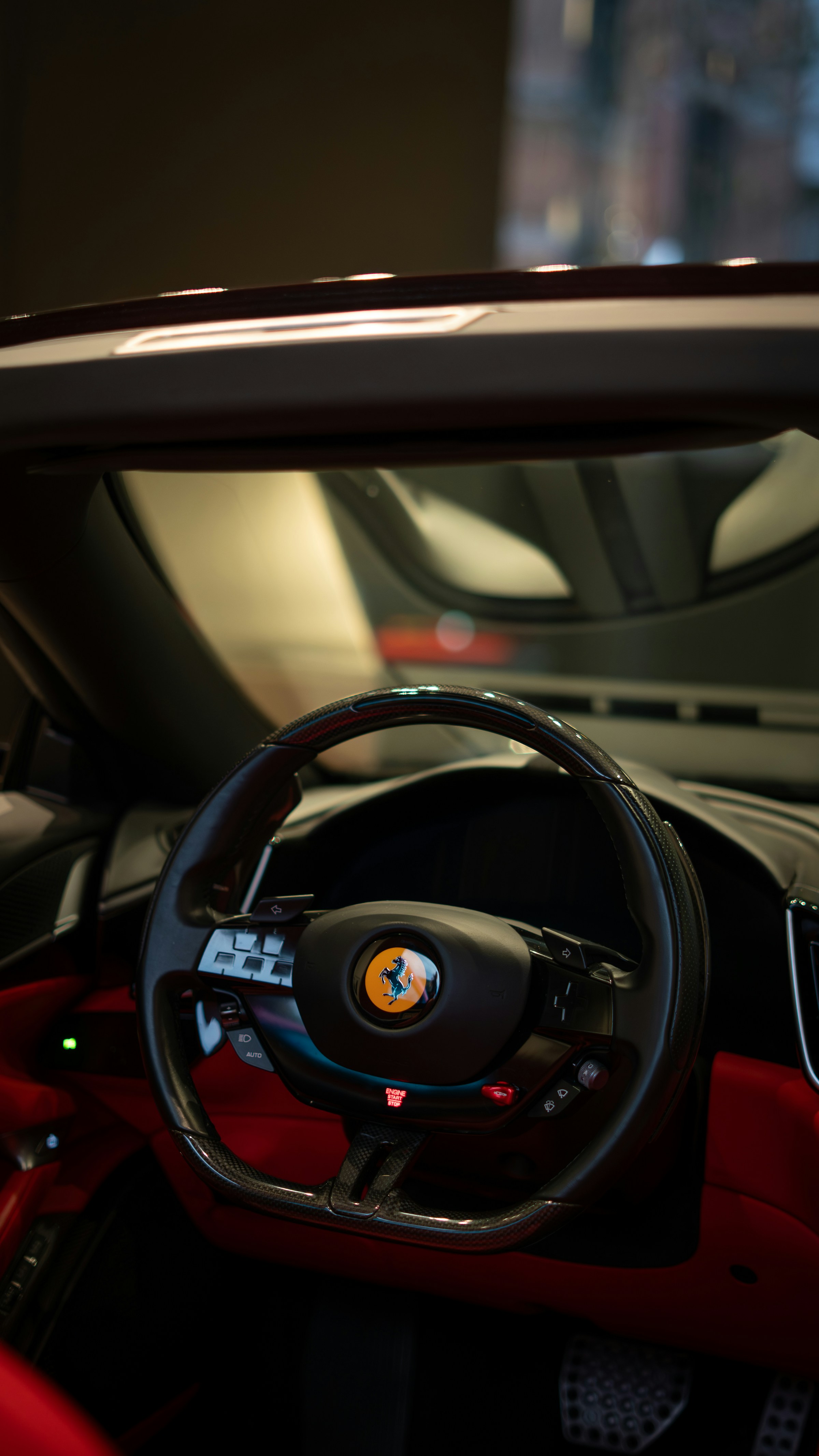 A Ferrari steering wheel and carbon fibre interior detail